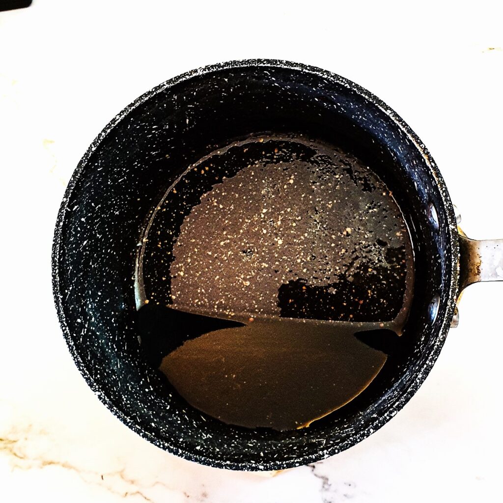 Balsamic and sugar glaze in a saucepan.
