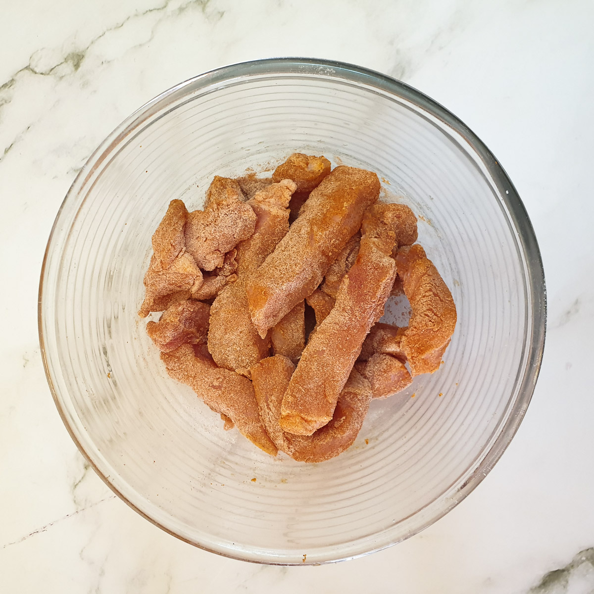 Raw pork fingers coated in seasoned flour.