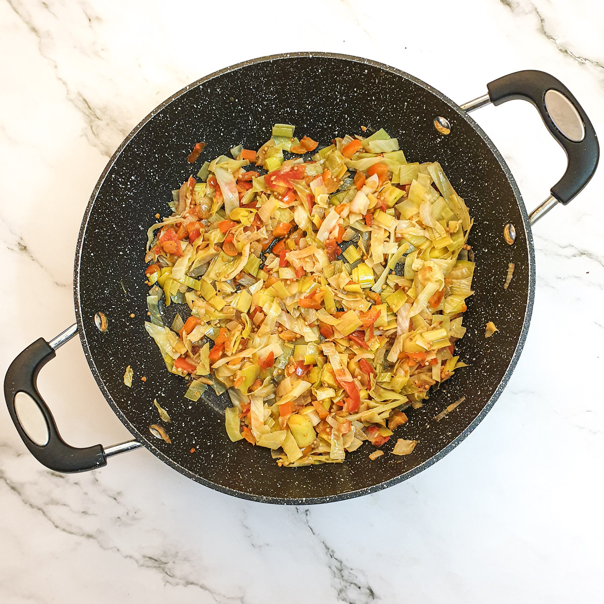 Cooked cabbage stuffing in a frying pan.