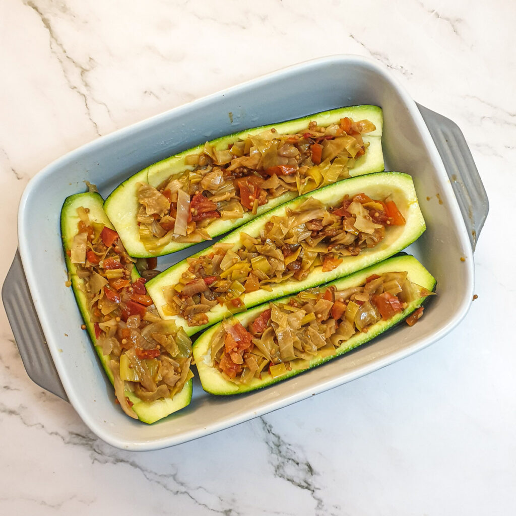 4 hollowed courgettes stuffed with cabbage mixture.