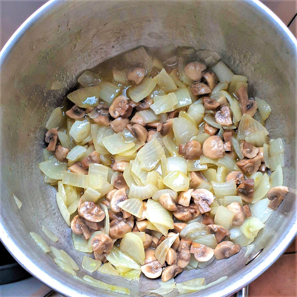 Saute'd onions and mushrooms in a saucepan.