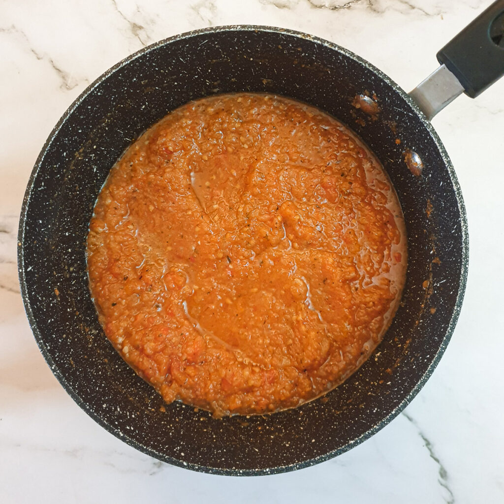 A saucepan of marinara sauce.