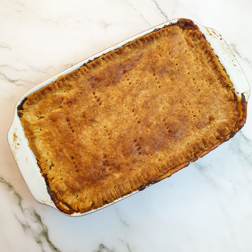 A cooked meat and potato pie.