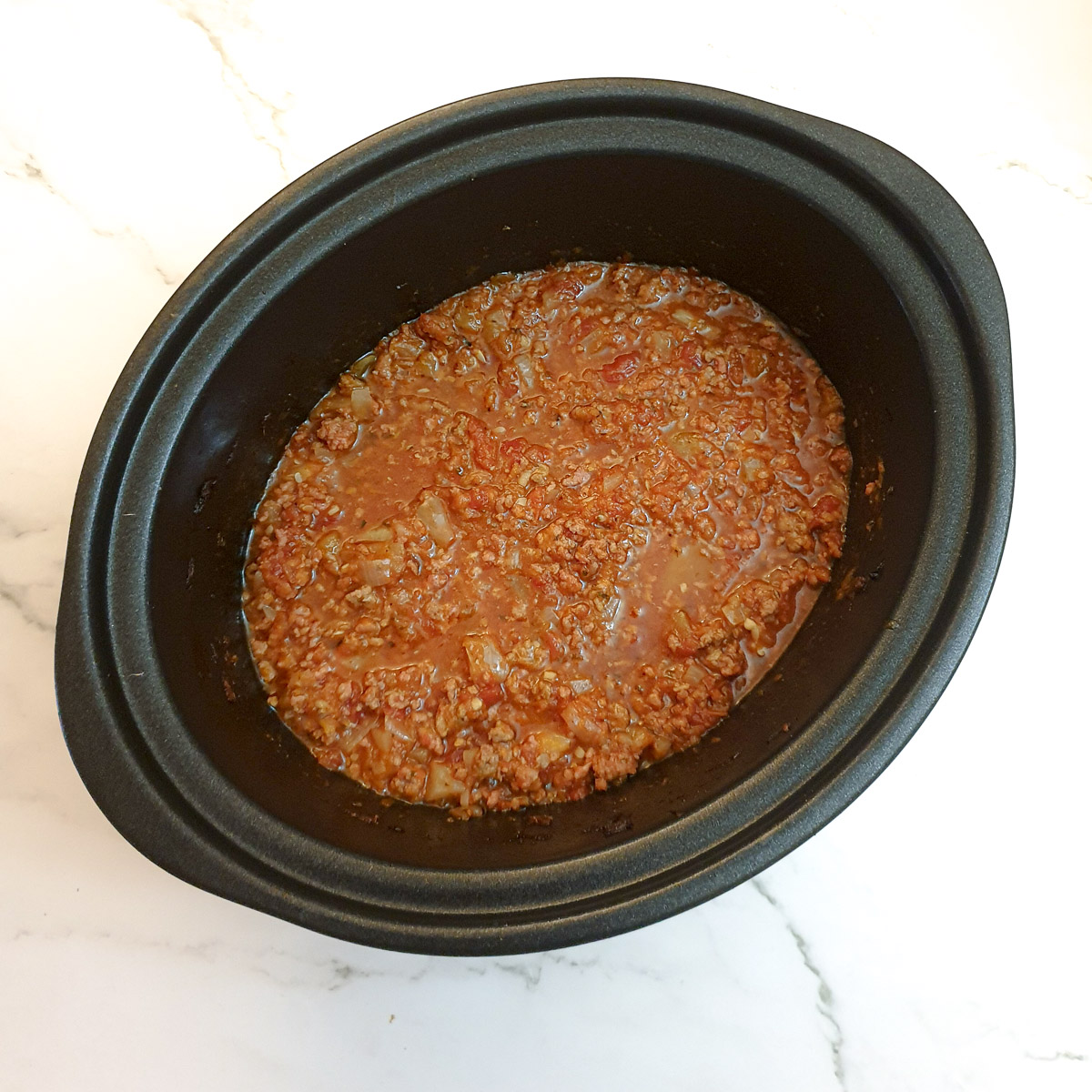 Cooked bolognese sauce in a slow-cooker.