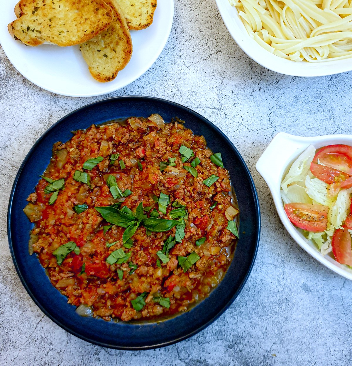 Overhead shot of slow-cooker bolognese sauce in a serving dish.