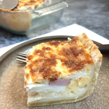 A slice of South African savoury tart on a plate.