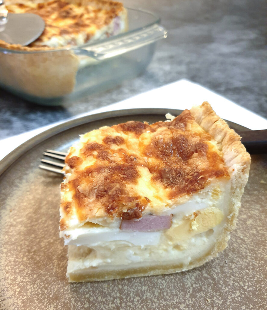 A slice of South African savoury tart on a plate.