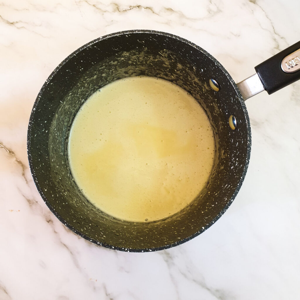 A mixture of butter and cornflour in a saucepan.