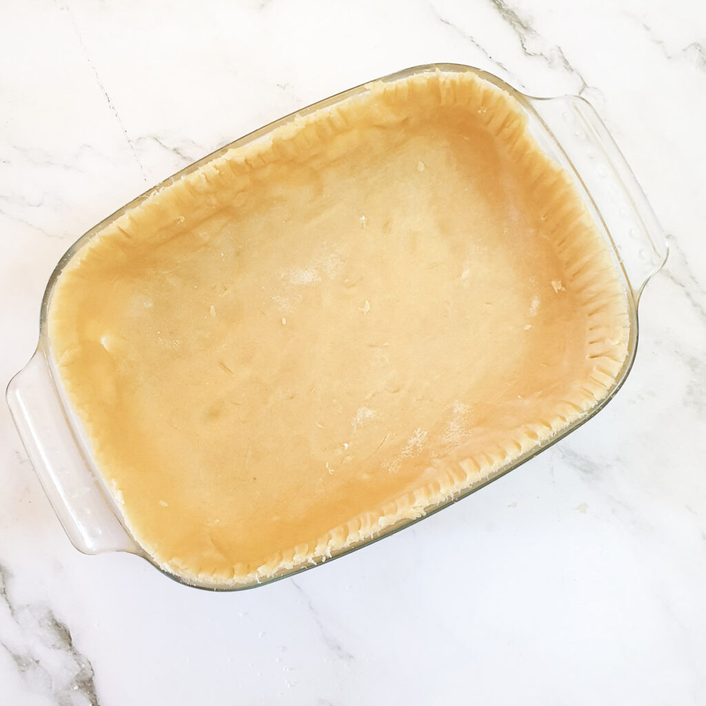 A baking dish lined with pastry.