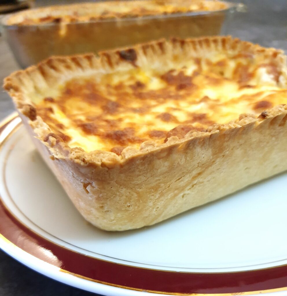 Close up of a savoury tart on a plate.