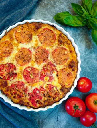 Overhead shot of a crustless tomato and onion quiche.
