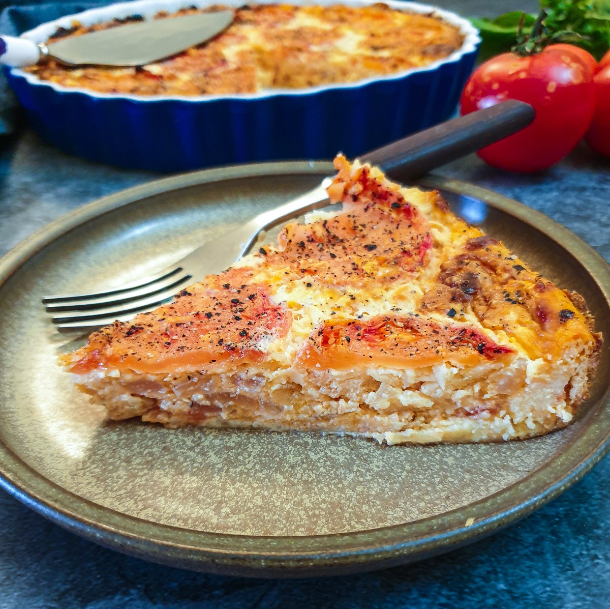 A slice of crustless tomato quiche on a plate.