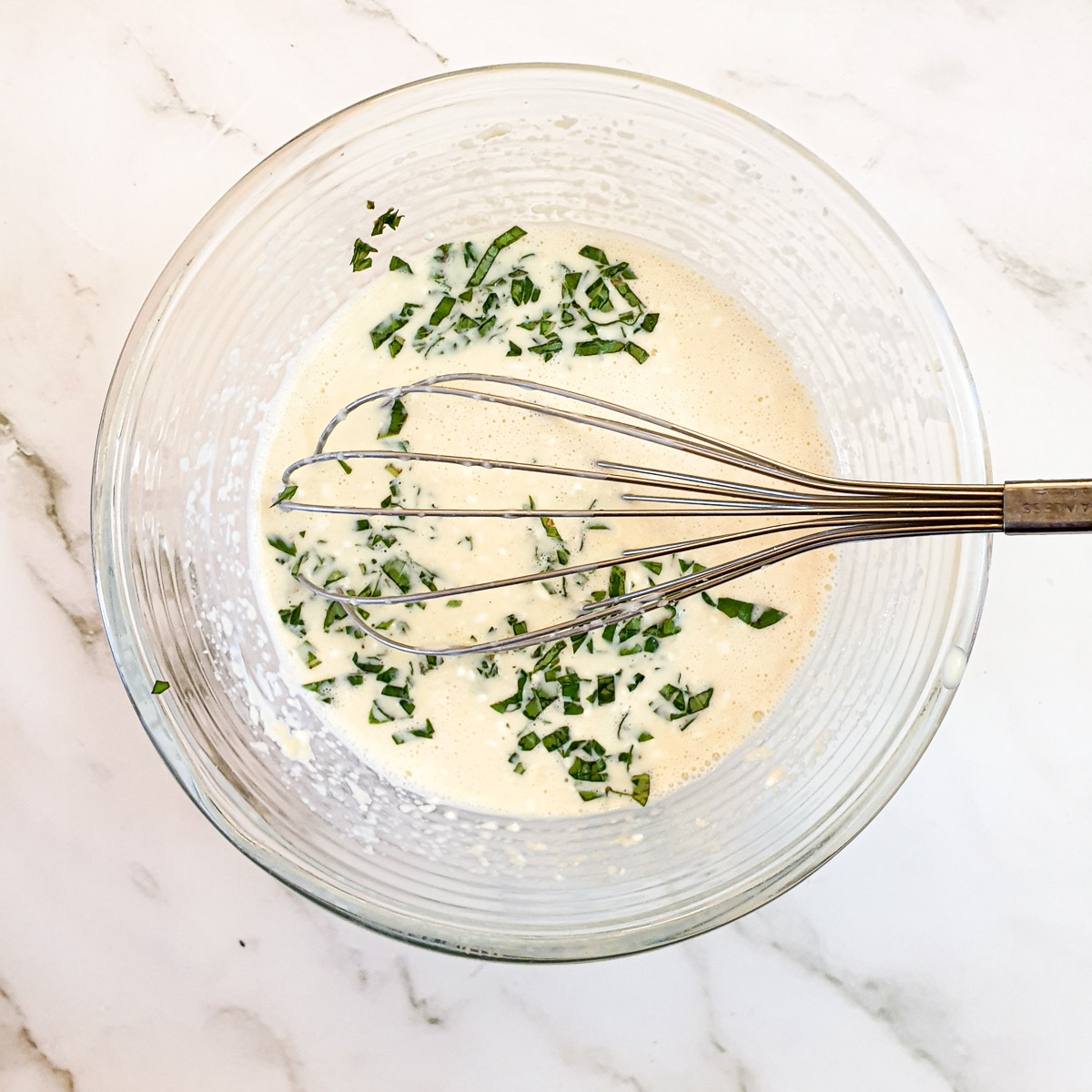 Chopped basil mixed with cream cheese, eggs and milk.