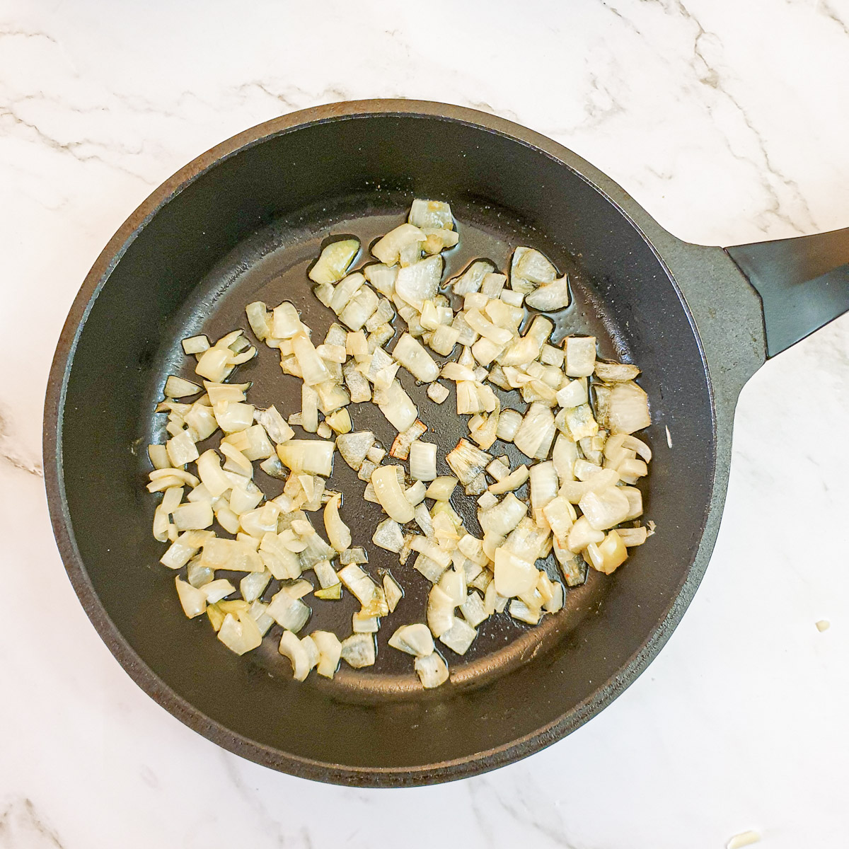 Diced onions in a frying pan.