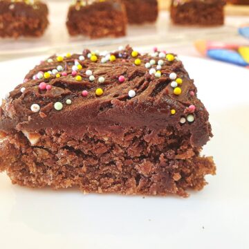 Close up of chocolate weetbix crumble cake with more slices out of focus in the background.