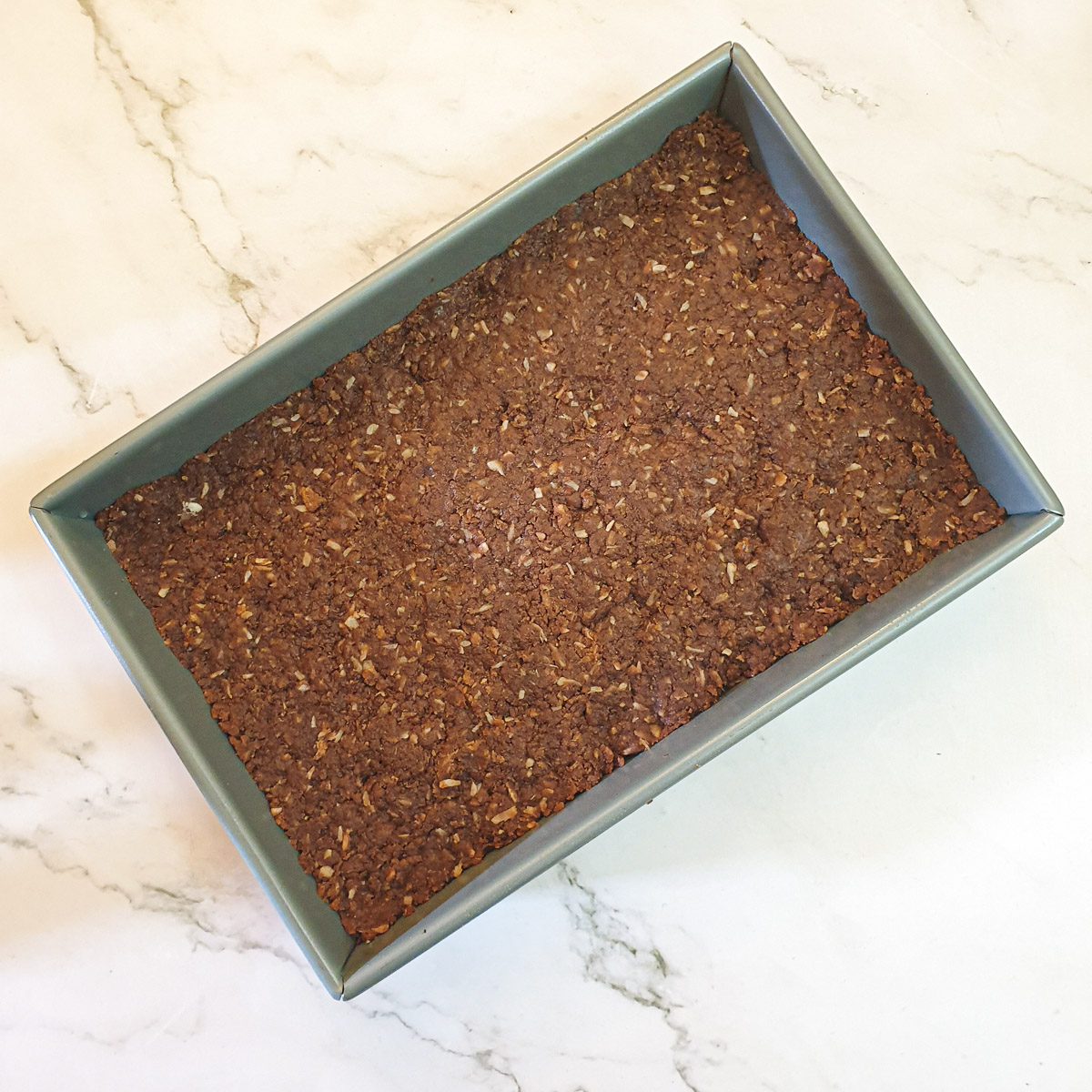 Chocolate weetabix cake batter in a baking dish.