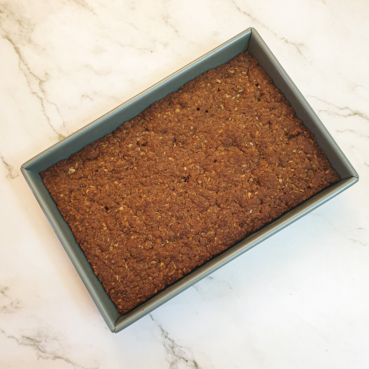 A baked weetabix slice in a baking dish.