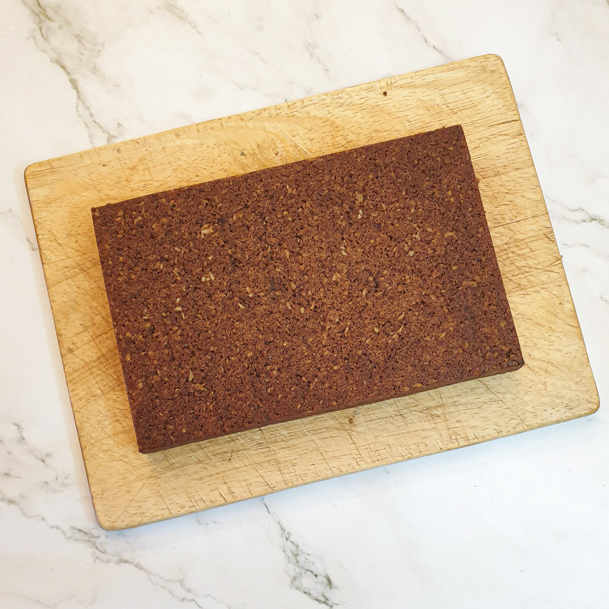  baked chocolate weetabix crumble slice on a wooden board.