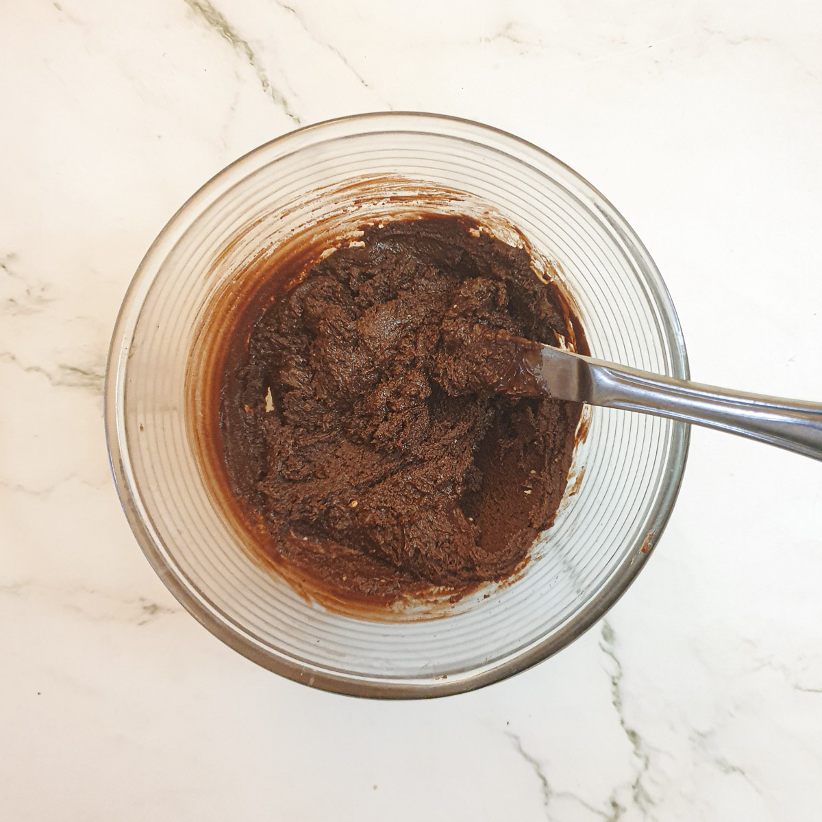 Chocolate icing in a mixing bowl.