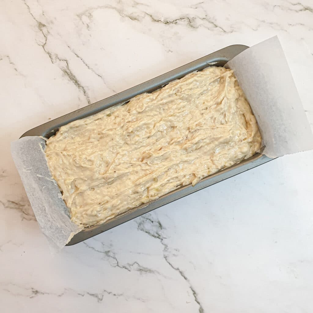 Pear and banana loaf batter in a loaf tin.