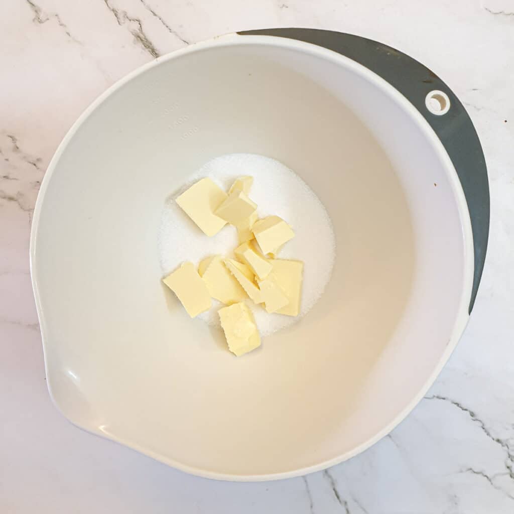 Butter and sugar in a mixing bowl.