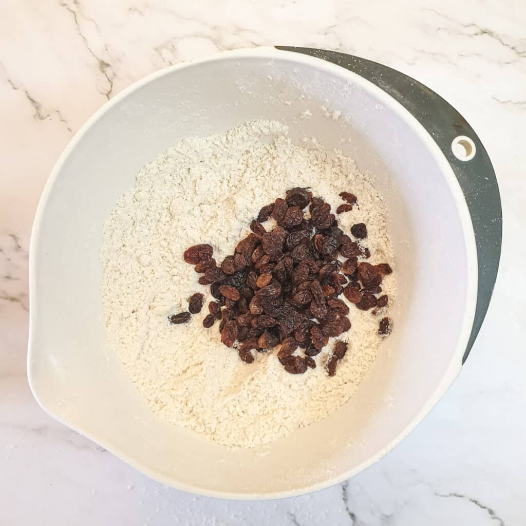 Sultanas being added to the scone dough.