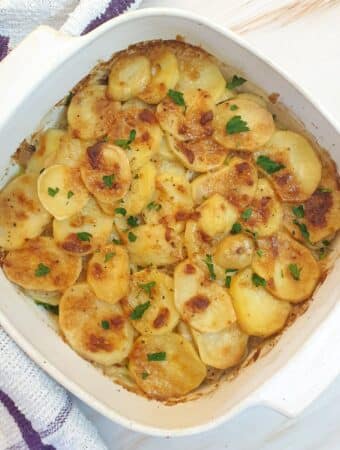 A dish of boulangere potatoes with a crispy cheese topping.