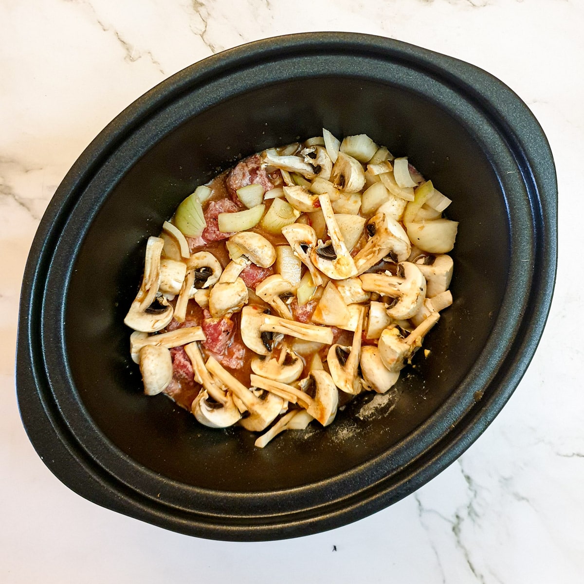 All the ingredients for beef stroganoff in a slow-cooker.