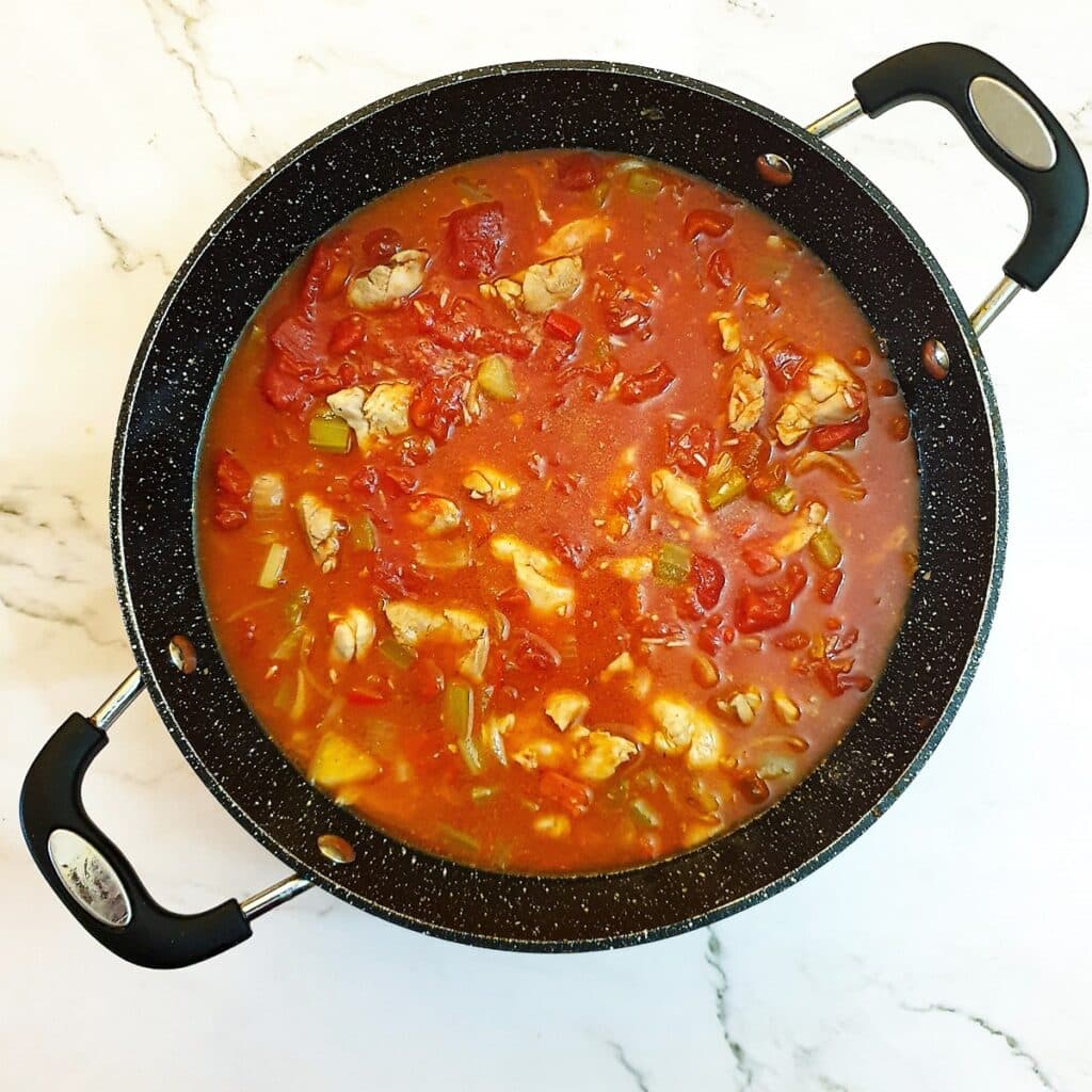 Tomatoes and stock added to the Jambalaya.