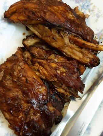 A pile of succulent barbeque pork spare ribs on a plate.