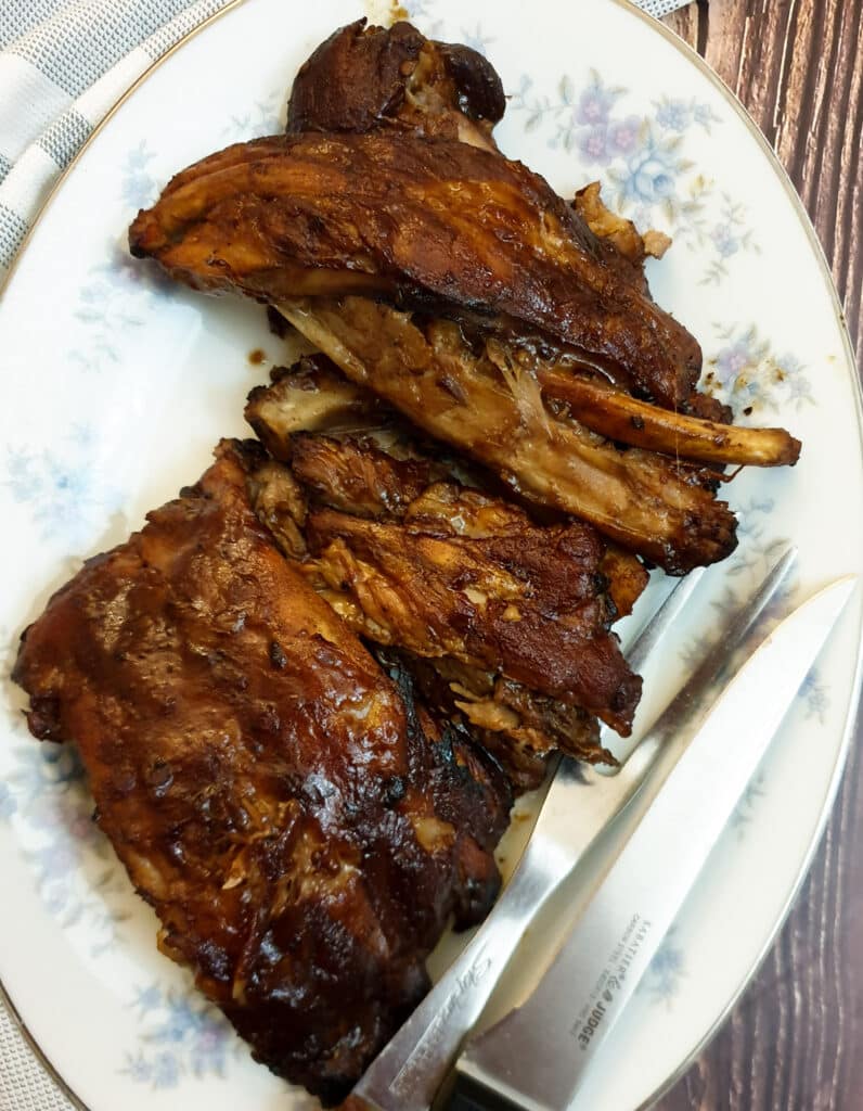 A pile of succulent barbeque pork spare ribs on a plate.