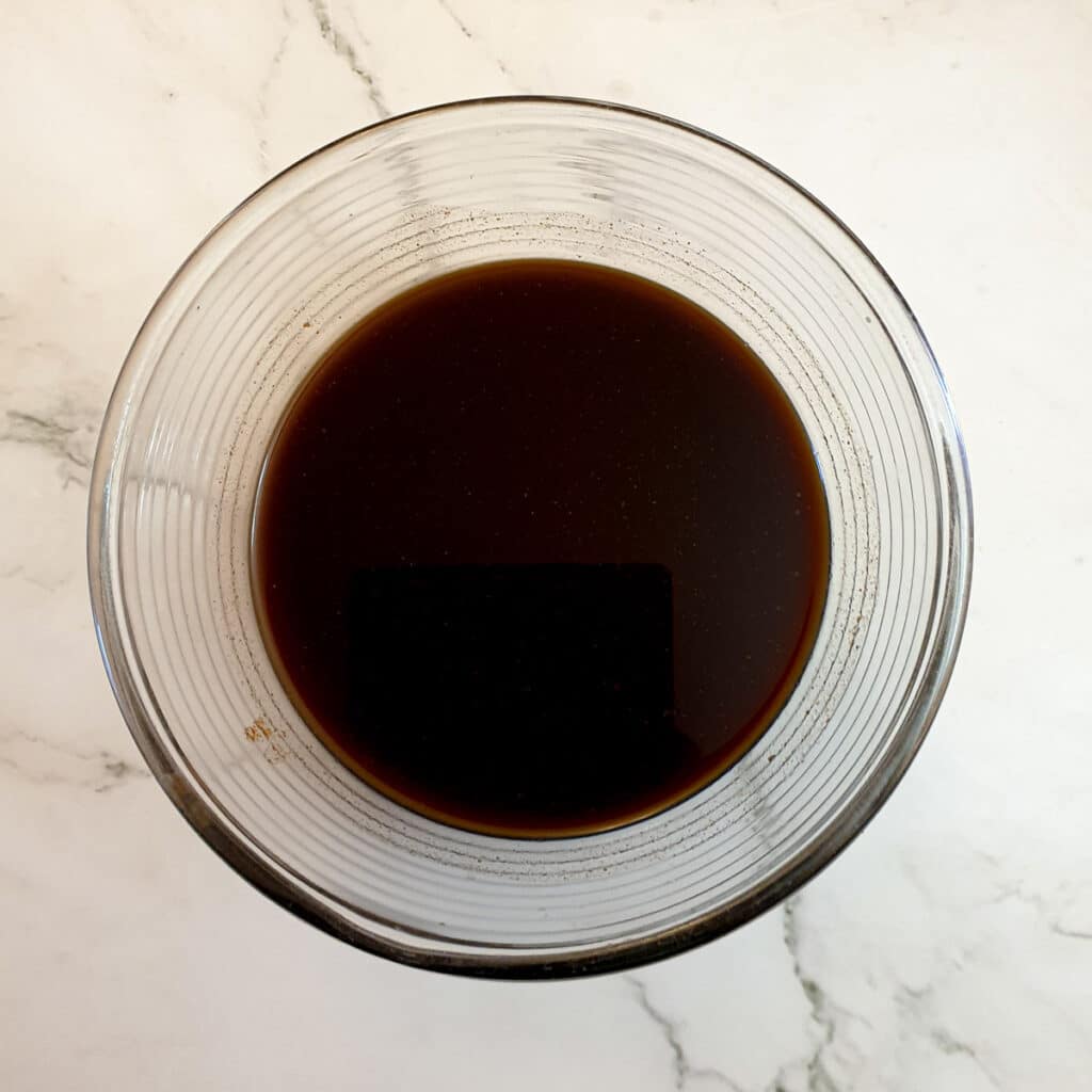 A mixing bowl containing barbeque sauce.