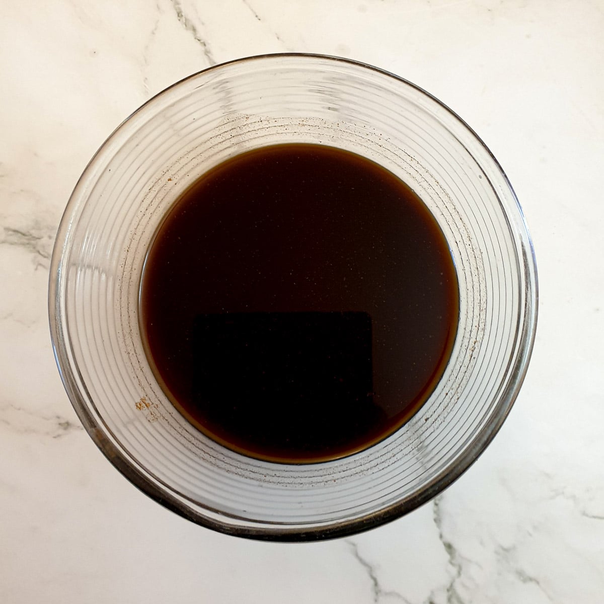 A mixing bowl containing barbeque sauce.