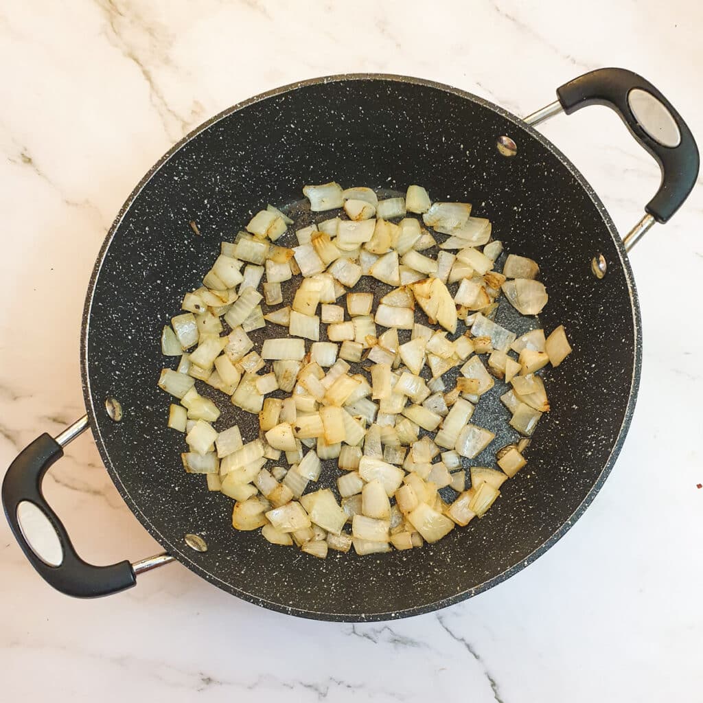 Chopped onions in a frying pan.