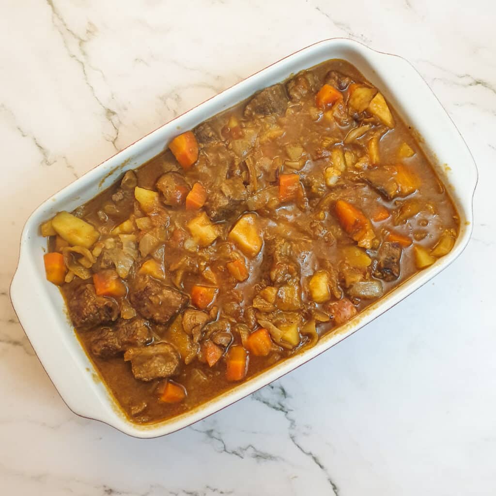 Filling for steak and kidney pie in a baking dish.