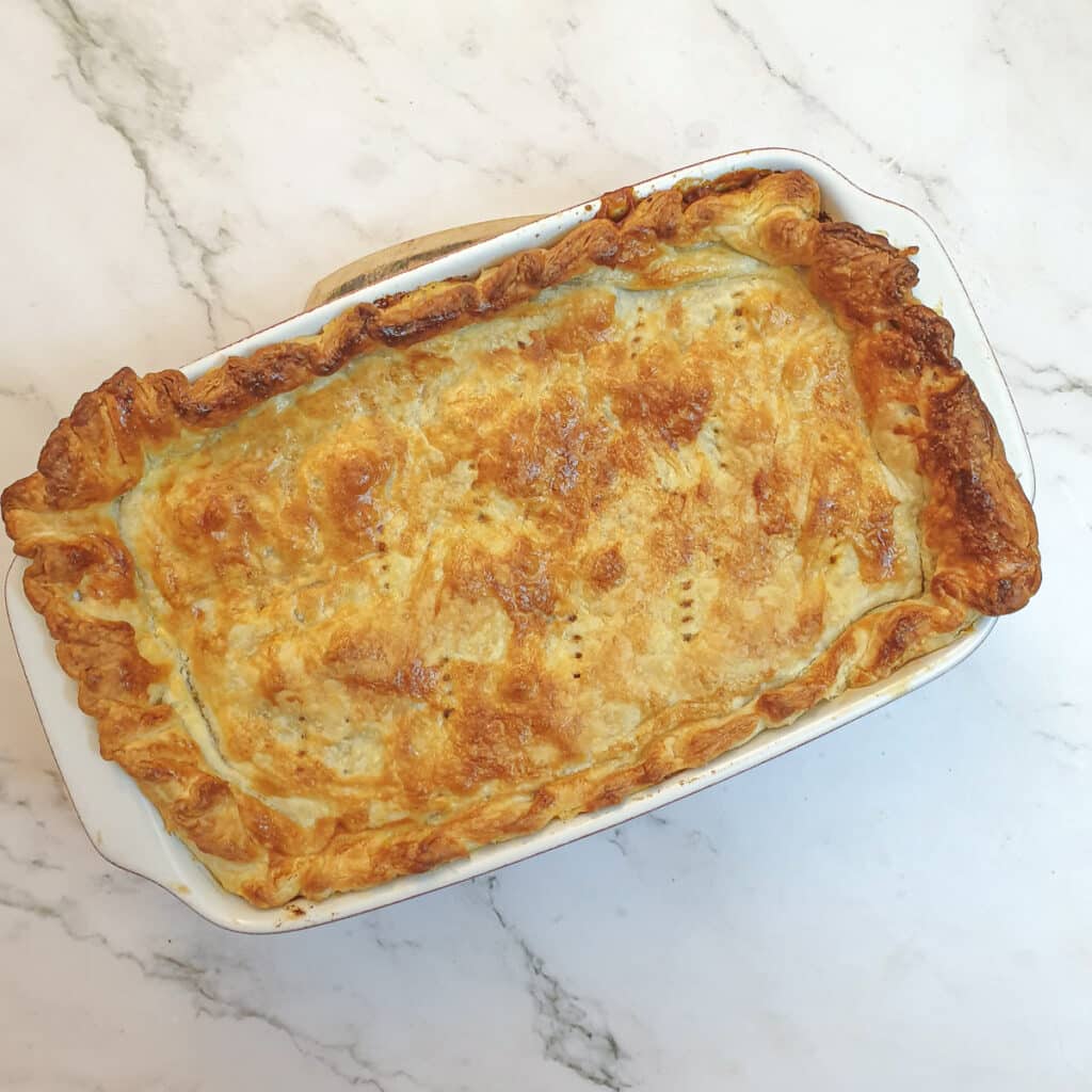 A golden brown steak and kidney pie fresh from the oven.