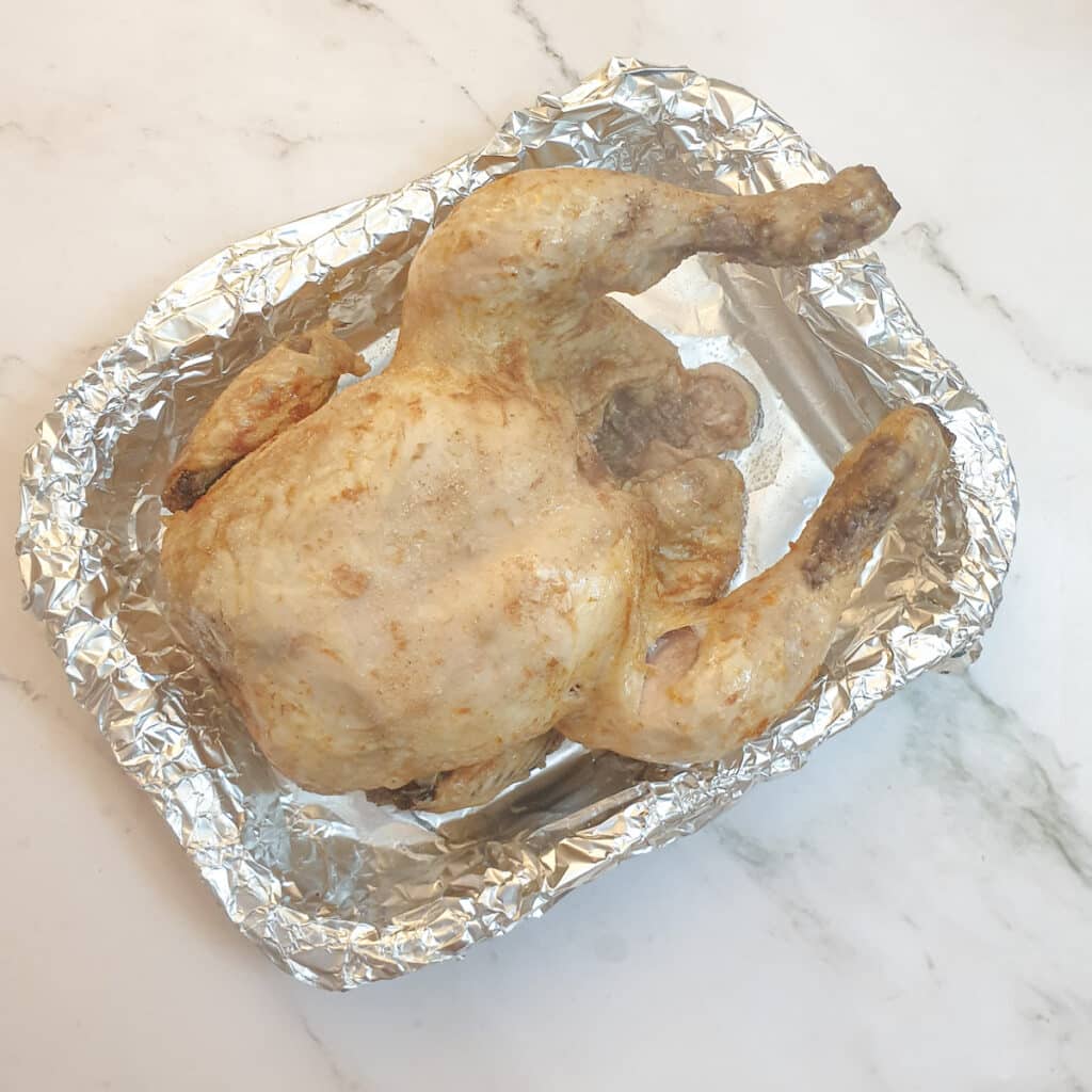 A slow-cooker roast chicken before being browned in the air-fryer.