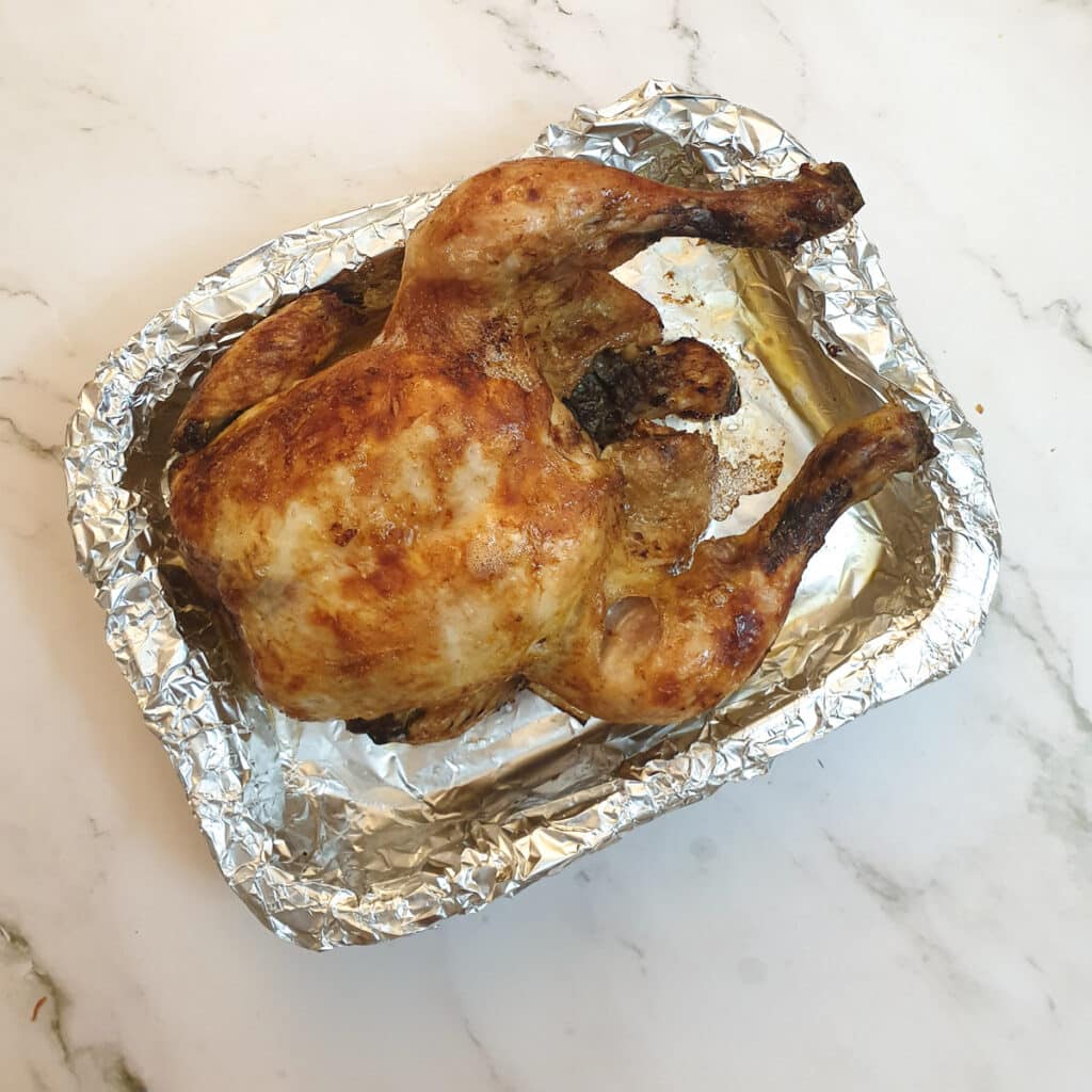 A slow-cooker chicken after being browned in the air-fryer.