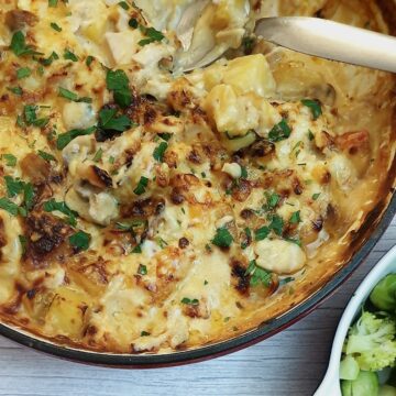 A close up of dish of cheesy potato and chicken bake.