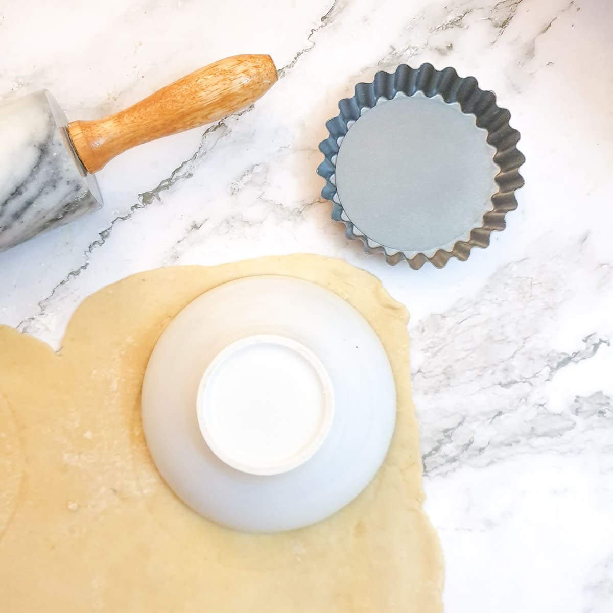 Rolled pastry being cut to size.