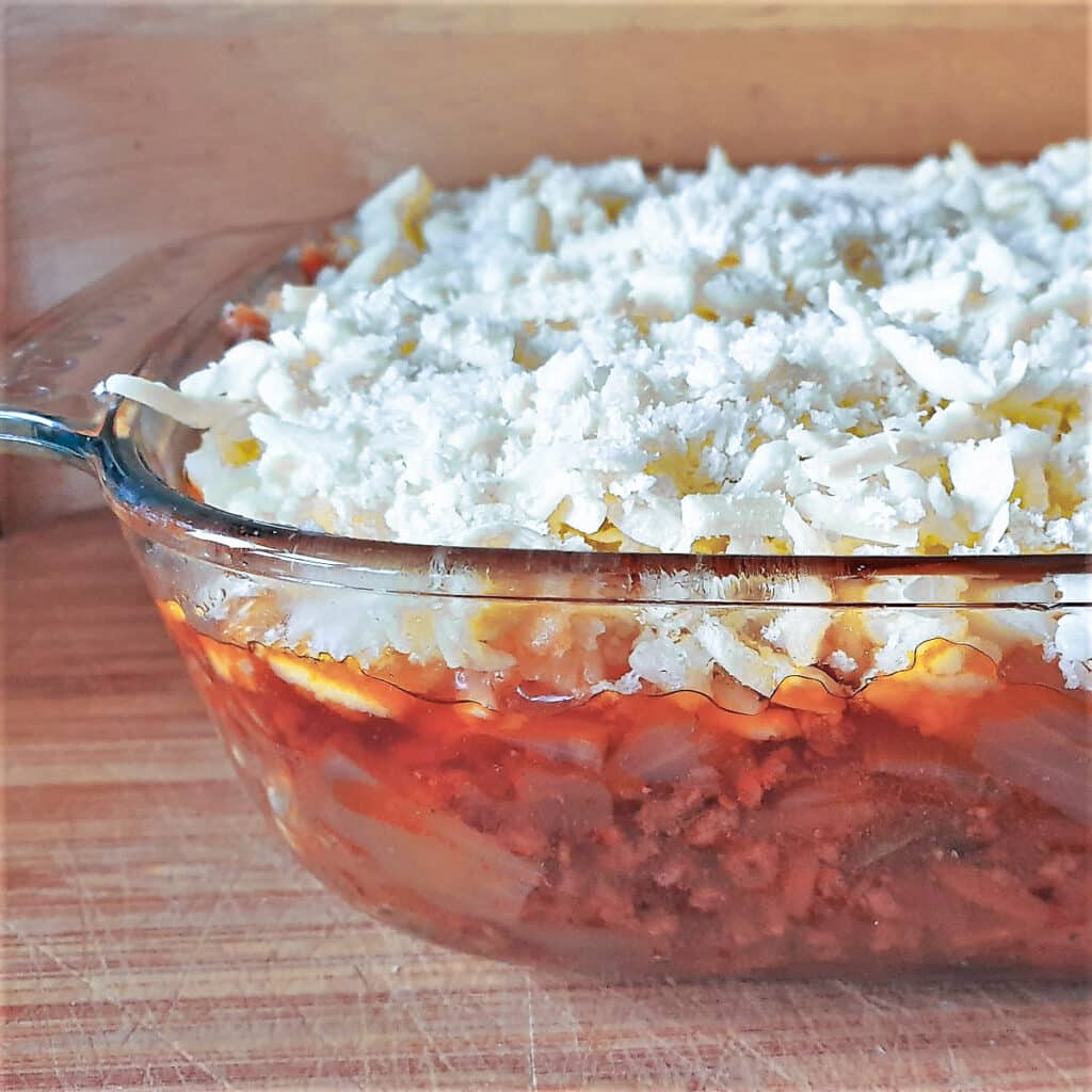 A dish of cottage pie ready to be browned in the oven.