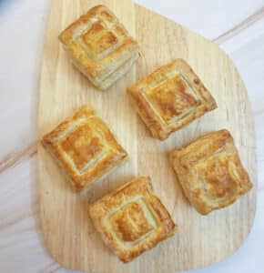 5 vol-au-vents on a wooden plank.