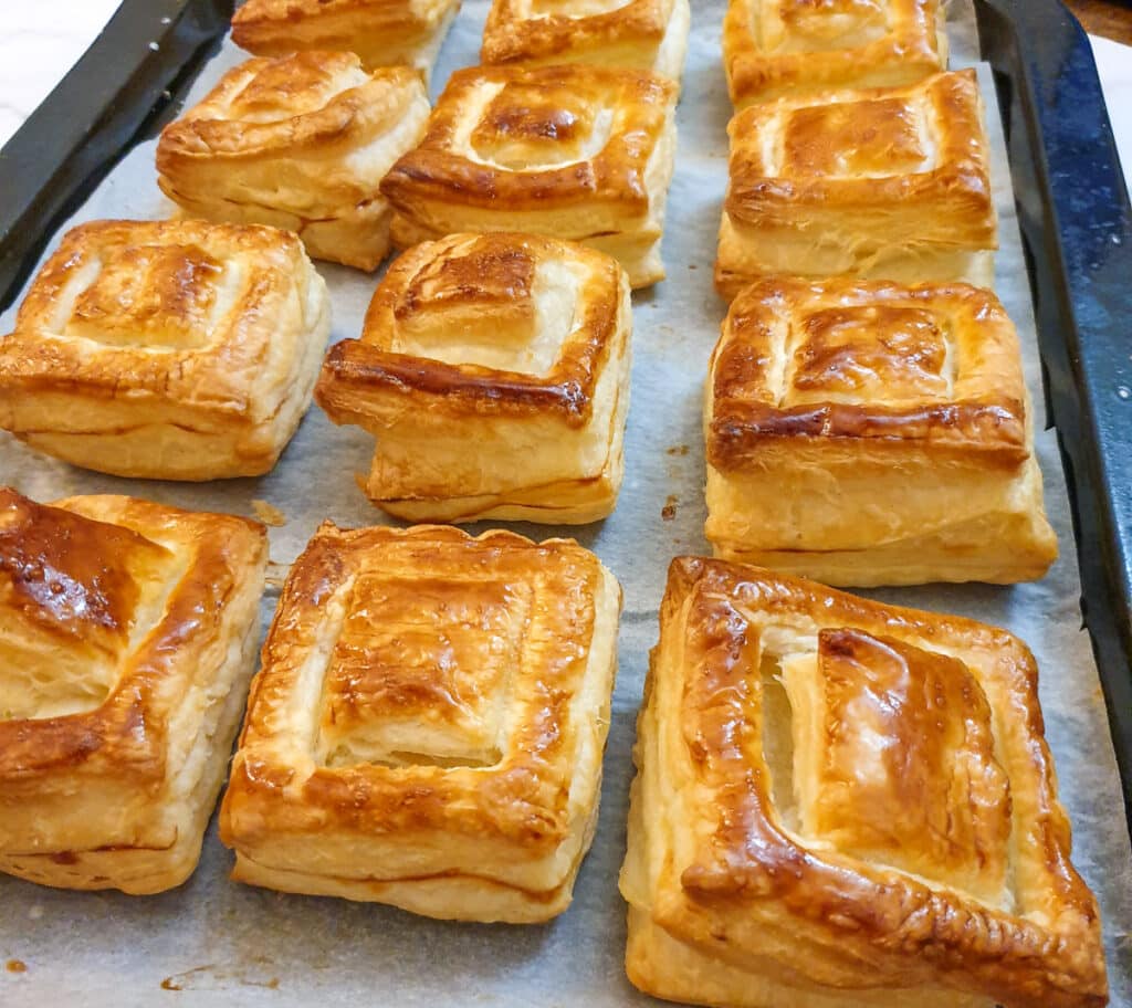 Close up of 12 baked vol-au-vent shells.