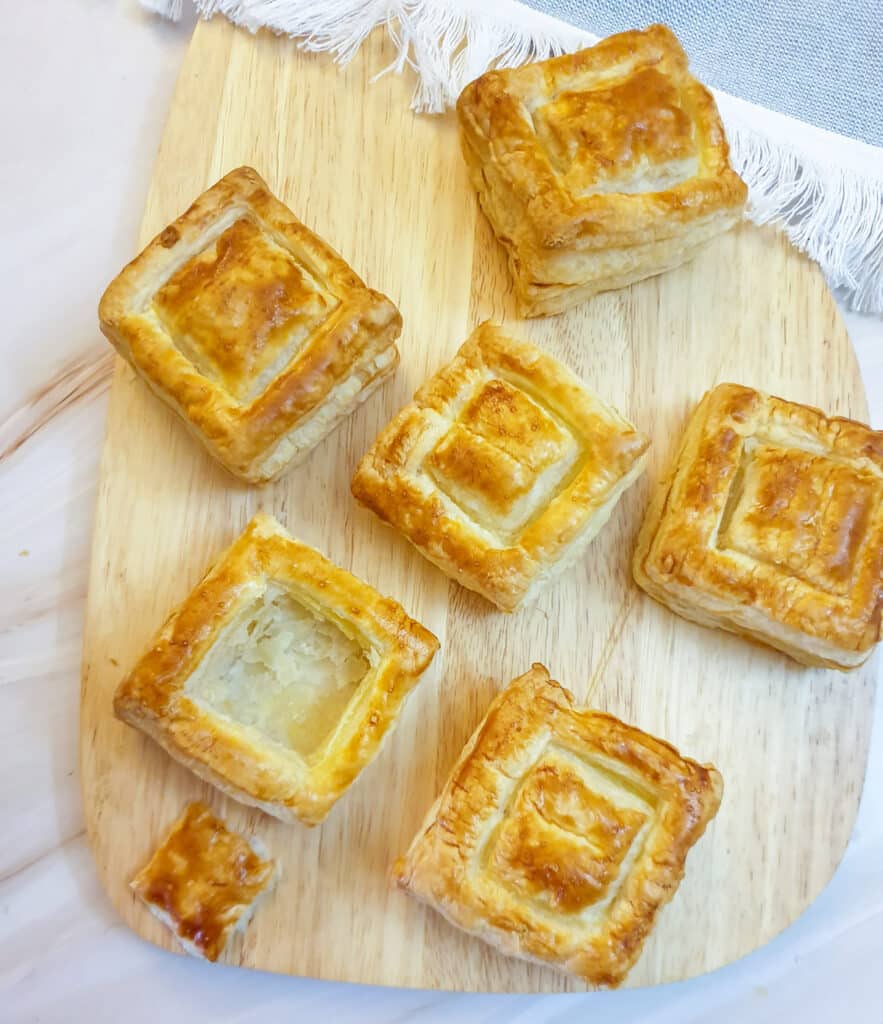 6 vol-au-vent shells on a wooden board.