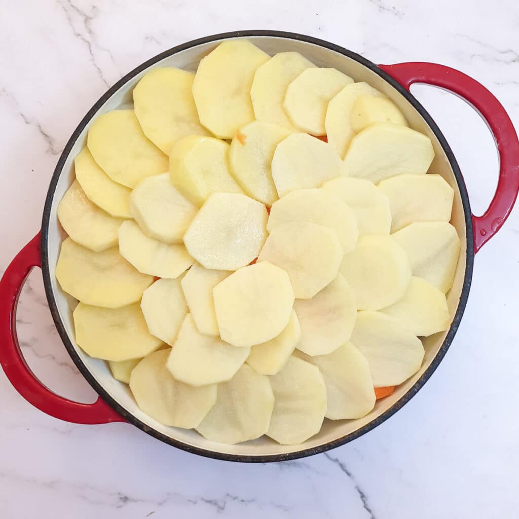 A layer of potatoes arranged on the Lancashire hotpot.