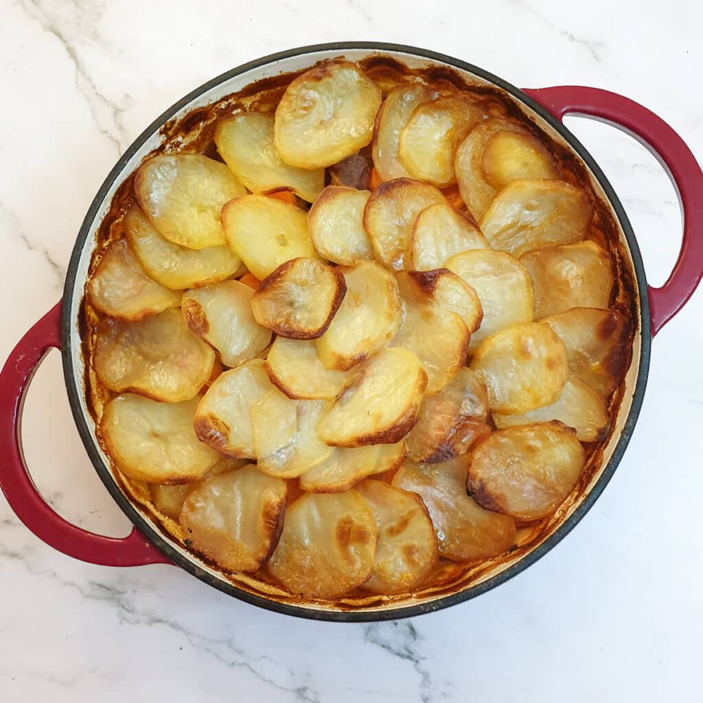 A dish of lancashire hotpot after the potatoes have been browned.