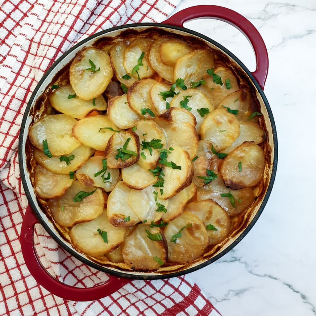 Lancashire hotpot covered with browned sliced potatoes.