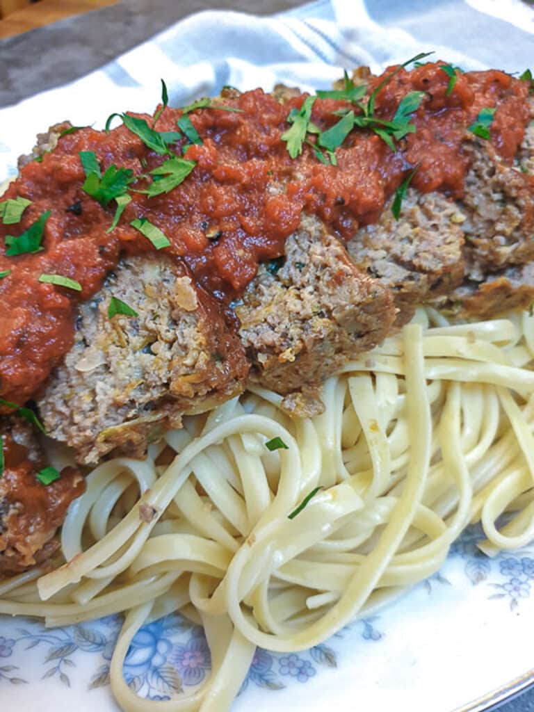 Slices of meatloaf on a bed of pasta, smothered with delicious marinara sauce.