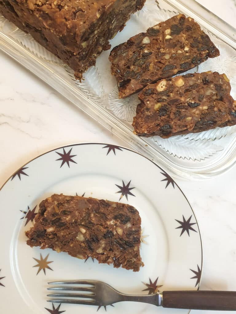 A slice of Christmas cake on a plate decorated with stars.