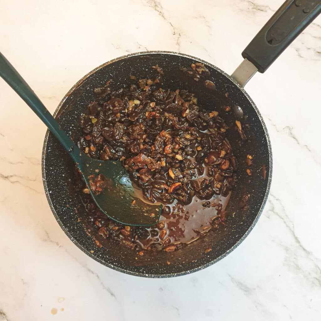 Chocolate melted into a pan of dried fruit.